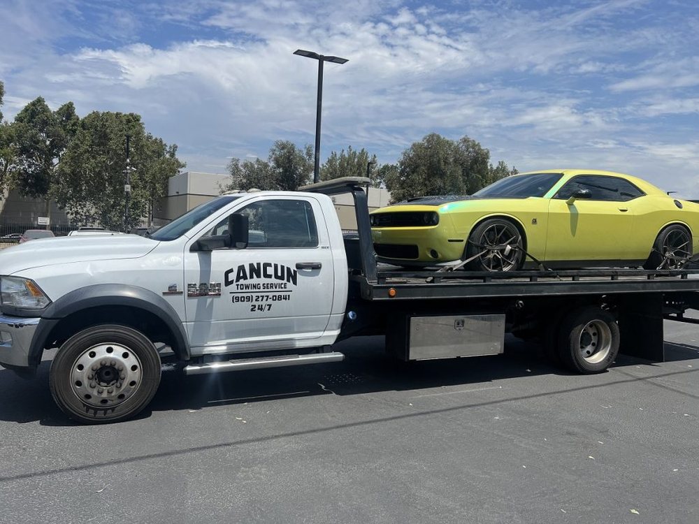 Cancun Towing Service flatbed loaded with a yellow muscle car