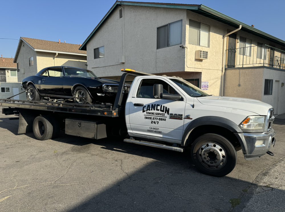 Classic muscle car being towed on a flatbed