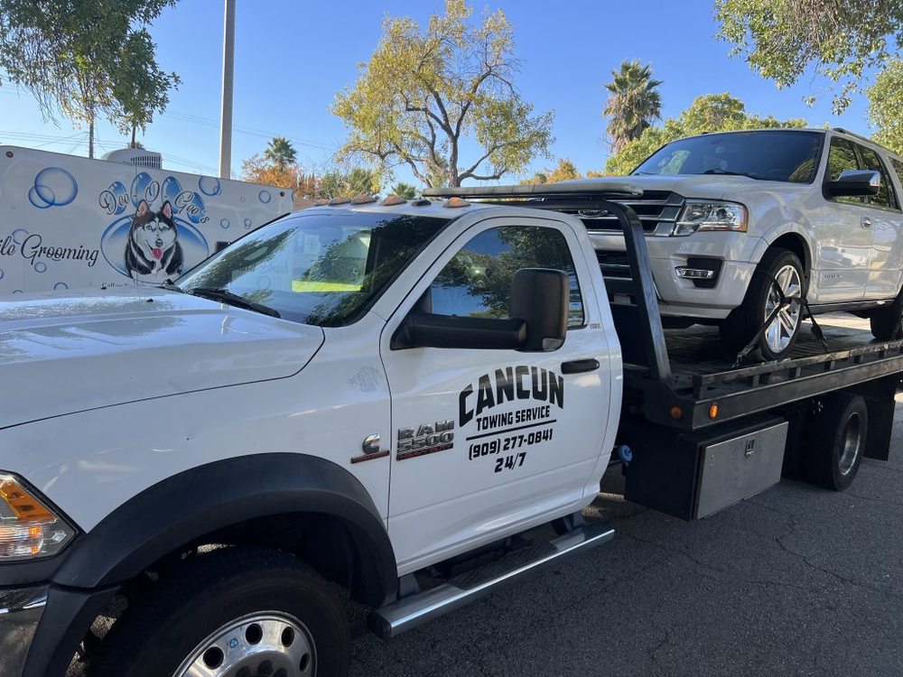 White SUV secured on the Cancun Towing flatbed